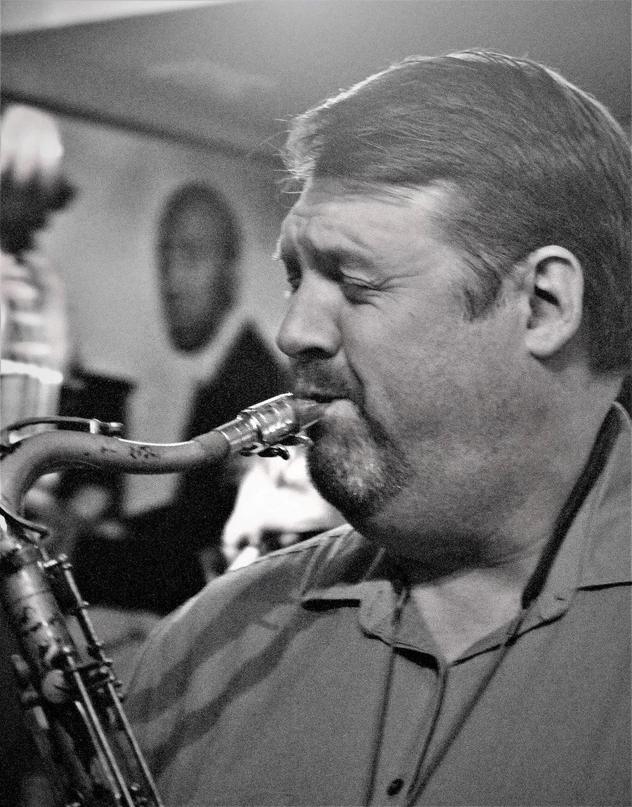 A black and white photo playing tenor saxophone.